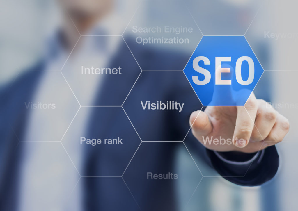 Search Engine Optimization consultant touching SEO button on whiteboard